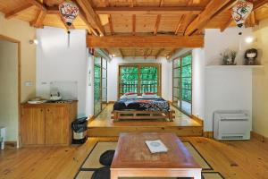 a bedroom with a bed in the middle of a room at La Cabane Zen in Angoisse