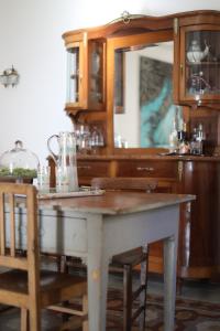 a dining room with a table and some chairs at Casa Aulivo, dimora storica con vista in Caiazzo +13 photos