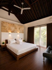 a bedroom with a large bed and a ceiling fan at Villa Layar with Private Pool and Ocean View in Lajor +27 photos