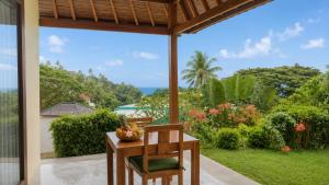a table and chairs with a bowl of fruit on it at Villa Layar with Private Pool and Ocean View in Lajor
