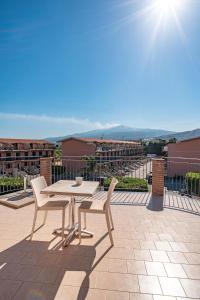 a table and two chairs on a patio with a view at New Naxian Holidays in Giardini Naxos