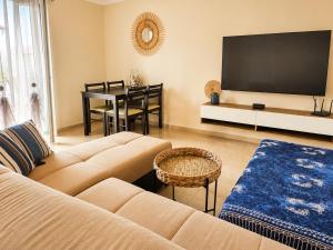 a living room with a couch and a table at KRAKEN Apartment in Leptokarya