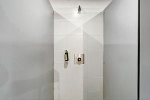 a bathroom with a shower with white tiles at La Cabane Zen in Angoisse +19 photos