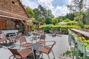 a group of chairs and tables on a patio at La Cabane Zen in Angoisse