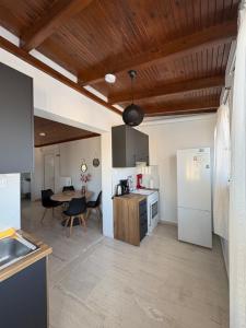 a kitchen with white appliances and a table with chairs at Sisyphys Kingdom in Korinthos