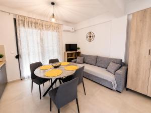 a living room with a table and a couch at Crystal 2 Apartment Ofrinio in Ofrínion