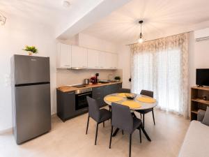 a kitchen and dining room with a table and chairs at Crystal 2 Apartment Ofrinio in Ofrínion +5 photos