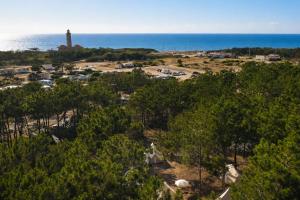 an aerial view of a parking lot with a lighthouse at Kampaoh São Pedro de Moel in Marinha Grande