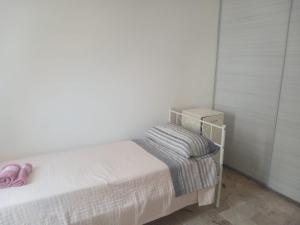 a bedroom with a bed with pink shoes on it at appartamento 4 piano in Chioggia +1 photo
