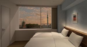 a bedroom with a bed and a window with a view at B:CONTE Asakusa in Tokyo +58 photos