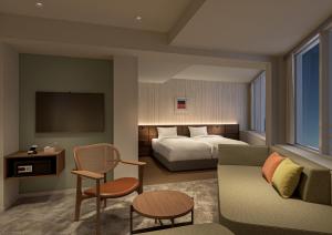 a hotel room with a bed and a couch at B:CONTE Asakusa in Tokyo