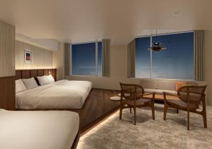 a hotel room with a bed and a table and chairs at B:CONTE Asakusa in Tokyo