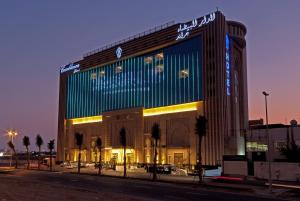a large building with a sign on top of it at Casablanca Grand Hotel in Jeddah