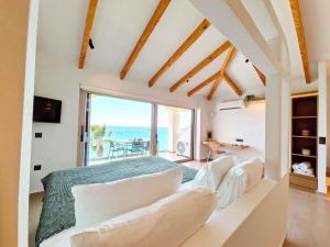 a bedroom with a view of the ocean at Panorama Inn in Lithakia