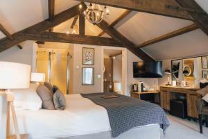a bedroom with a large bed and a tv at Yorebridge House in Bainbridge