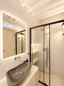 a bathroom with a sink and a shower at Cozy apartments Paros Kostos in Kóstos +32 photos