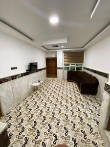 a living room with a couch and a carpet at Bani motel in Duhok