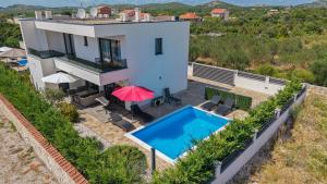 an aerial view of a house with a swimming pool at Villa Adriatic Sunrise in Šibenik