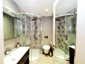 a bathroom with a shower and a toilet and a sink at Hotel Lina Oldcity in Istanbul
