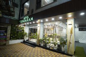 a store front with potted plants in front of it at Hotel New Sundaram 150 Mtrs from Dargah in Ajmer