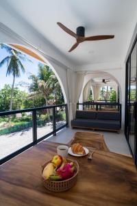 a table with a bowl of fruit and a plate of food at Aqueduct resort in Ko Tao