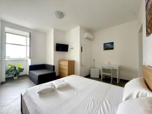 a bedroom with a white bed and a chair at Suite Home in Naples