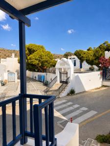 a view from a balcony of a street with white buildings at Cozy apartments Paros Kostos in Kóstos