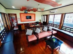 a living room with couches and a table at Eleeza Homestay in Cochin