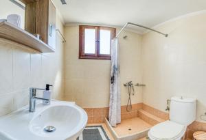 a bathroom with a toilet and a sink and a shower at Viri Blue in Ágios Ioánnis +27 photos