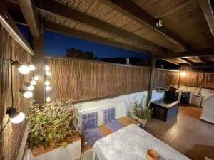 an outdoor patio with a table and a bench at Casa Mellis Aguamarga in Agua Amarga