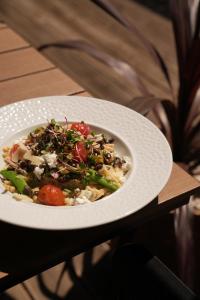 a white bowl of food on a table at Hotel Boss in Łódź +33 photos