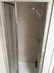a shower with a glass door in a bathroom at Hanavine Room in Moulton