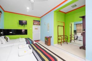 a living room with green and colorful walls at The Panorama Negombo in Negombo