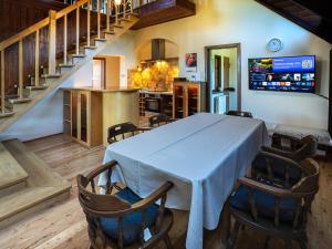 a dining room with a white table and chairs at Apartament ALINA in Kartuzy