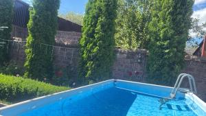 a swimming pool in a yard with trees at HIN TUN NAR-DOS Street in Gyumri