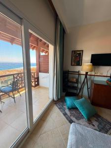 a living room with a view of the ocean at Club Red Dahab Motel in Dahab