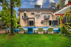a patio with chairs and a table in front of a house at The Panorama Negombo in Negombo