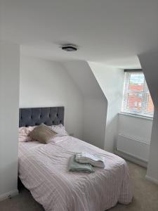 a bedroom with a bed with a blanket and a window at Hanavine Room in Moulton