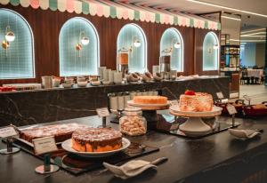 a bakery with cakes and other desserts on display at Fazzenda Park Resort in Gaspar