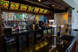 a bar with a lot of bottles of alcohol at The Grand Hotel in Llandudno