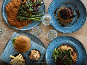 a wooden table with plates of food on it at Copthorne Hotel Cardiff-Caerdydd in Cardiff