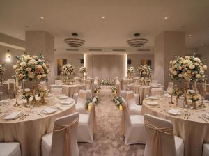 a banquet hall with white tables and chairs and flowers at Miapera Hotel & Spa - Special Class in Istanbul +47 photos