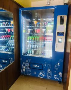 a blue drink cooler in a store with drinks at Hotel Am Flughafen in Cologne