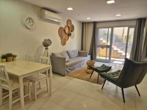 a living room with a table and chairs and a couch at Luna BaNeguev in Yeroẖam