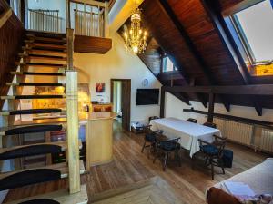 a room with a table and chairs and a staircase at Apartament ALINA in Kartuzy