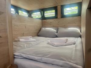 a room with two large white beds in it at Hausboot Resort Nordseeküste in Wilhelmshaven