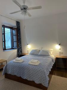 a bedroom with a bed with two towels on it at Casa Filita 'Old Town Traditional House' in Kos