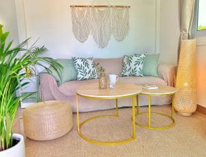 a living room with a couch and a table at Chaloklum Beach House in Chaloklum