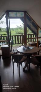 a room with a table and chairs and a balcony at Kaszubska Enklawa in Rytel