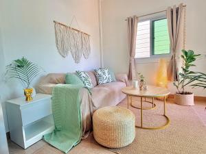 a living room with a couch and a table at Chaloklum Beach House in Chaloklum